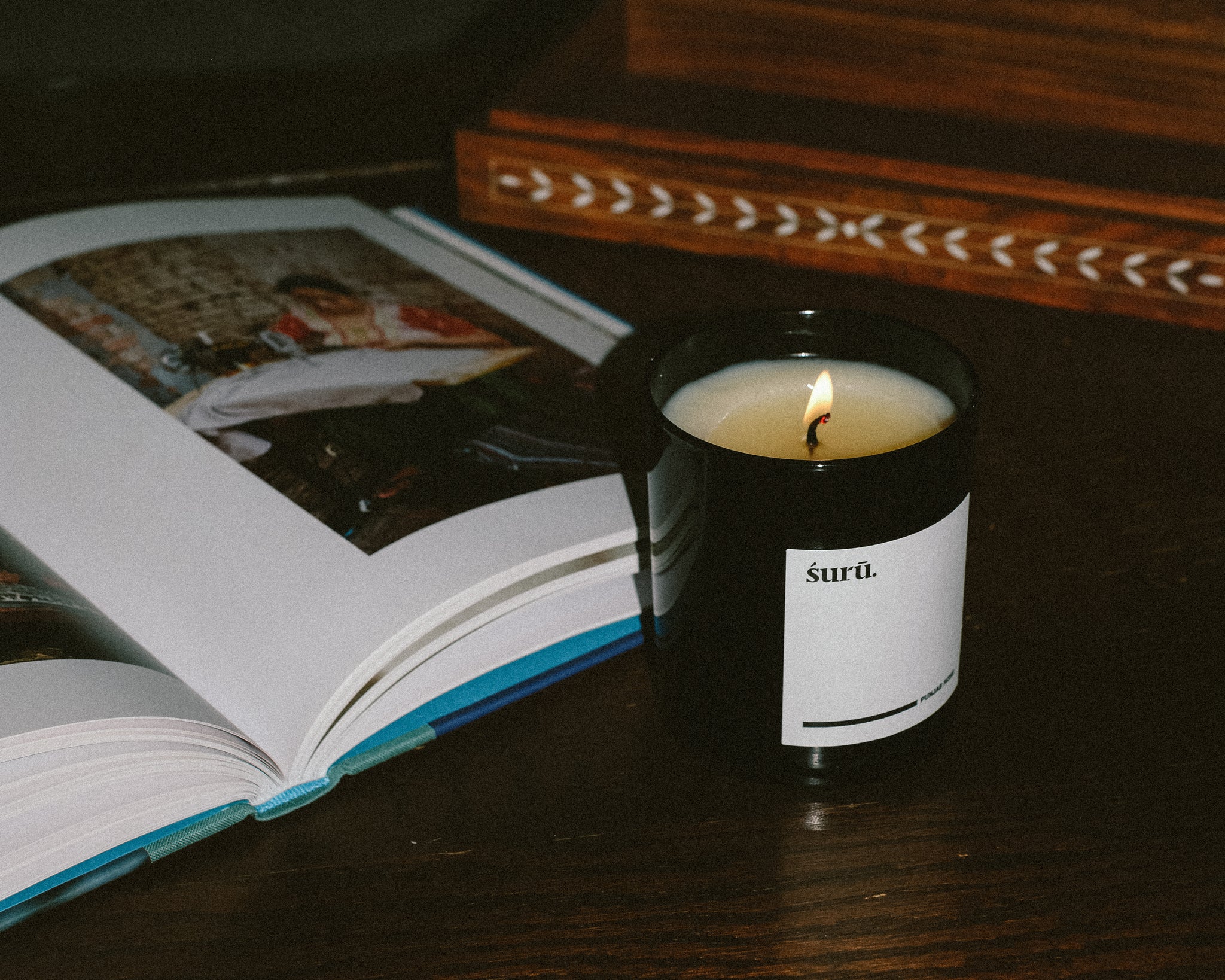 WHITE BESPOKE CANDLE PACKAGING ON BLACK BACKGROUND 